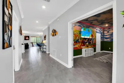 a hallway with a large painting on the wall at Magical Mickey Home 8 minutes from Disney STL109 in Kissimmee