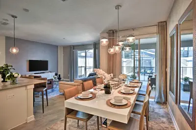 a dining room and living room with a table and chairs at The Windermere - Pool Lazy River & Waterslides in Kissimmee