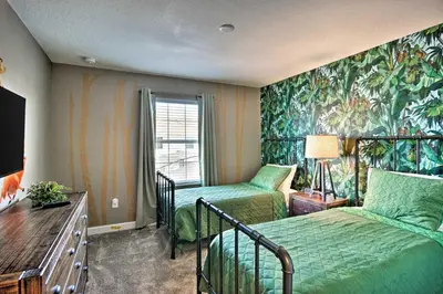 a hotel room with two beds and a window at The Windermere - Pool Lazy River & Waterslides in Kissimmee