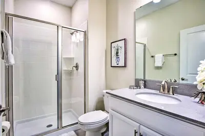 a bathroom with a shower and a toilet and a sink at The Windermere - Pool Lazy River & Waterslides in Kissimmee