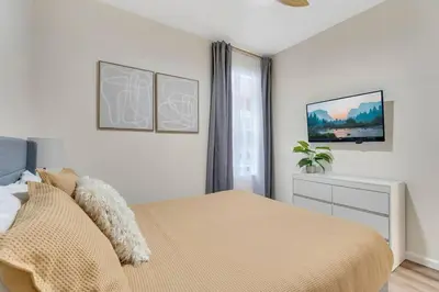 a white bedroom with a bed and a window at Immersive Themed Villa in Resort 4mi to Disney with Game Room and Private Pool in Orlando