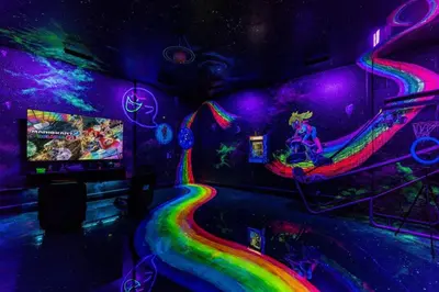 a room with a video game and a rainbow track at Immersive Themed Villa in Resort 4mi to Disney with Game Room and Private Pool in Orlando
