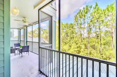 a balcony with a table and chairs and large windows at Modern 3BR Condo Near Disney- Pool in Orlando