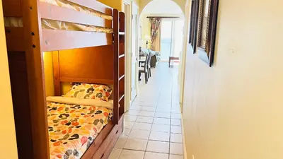 a bedroom with a bunk bed and a hallway at Blue Heron Beach Resort pet friendly in Orlando