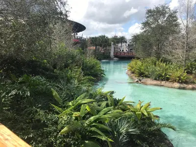 a river with turquoise water and a house in the background at Blue Heron Beach Resort pet friendly in Orlando