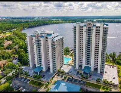 an aerial view of two tall buildings next to a river at Blue Heron Beach Resort pet friendly in Orlando