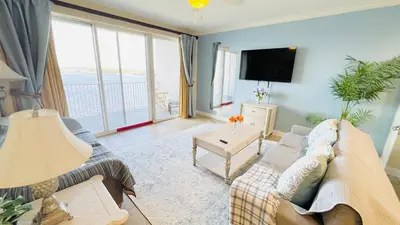a living room with a couch and a tv at Blue Heron Beach Resort pet friendly in Orlando