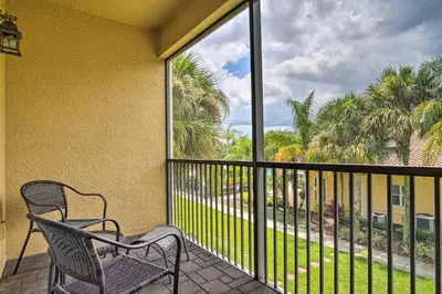 a balcony with a chair and a view of palm trees at Quiet Disney Condo w/ Balcony ~ 2 Miles to Disney World! in Orlando