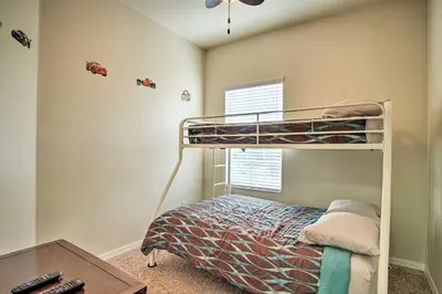 a bedroom with a bunk bed and a desk at Quiet Disney Condo w/ Balcony ~ 2 Miles to Disney World! in Orlando