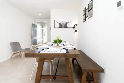 a dining room with a wooden table and chairs at Entire House close to Disney in Orlando