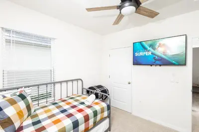 a bedroom with a bed and a ceiling fan at Entire House close to Disney in Orlando