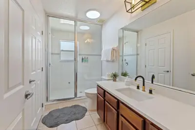 a bathroom with a sink and a shower and a toilet at Enjoyable 6BR Home Near Disney in Orlando