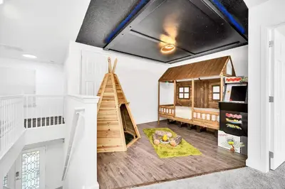 a childs room with a play area with a play house at Enjoyable 6BR Home Near Disney in Orlando