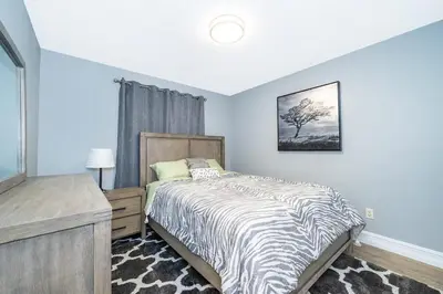 a bedroom with a bed with a zebra print blanket at Private Paradise! Stunning south-facing pool home in Kissimmee