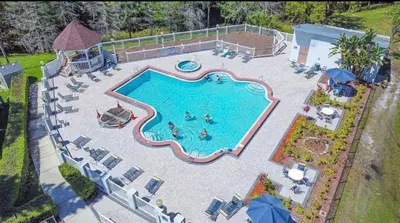 an aerial view of a swimming pool in a backyard at Sherwood Forest Mobile Home in Kissimmee