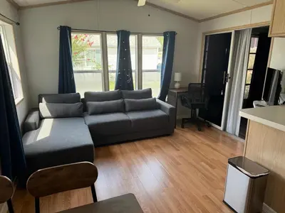 a living room with a couch and a table at Sherwood Forest Mobile Home in Kissimmee