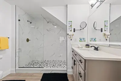 a white bathroom with a shower and a sink at The Villas at Seven Dwarfs - 2624 Mickey Villa - Near Disney - Water Park in Kissimmee