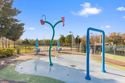 a playground with blue poles in a park at The Villas at Seven Dwarfs - 2603 Amazing Luxury Villa - Near Disney - Water Park in Kissimmee