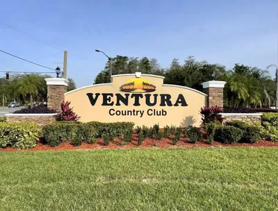 a sign for a county club in a park at Stunning Ventura Condo in Orlando