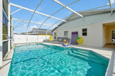 a swimming pool with a glass roof on a house at Minutes from Disney - Entertainment Haven with Pool in Orlando