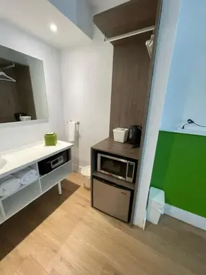 a bathroom with a sink and a mirror at Impeccably cozy hotel room Developer Inn Express in Kissimmee
