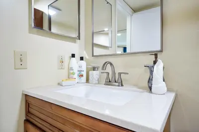 a bathroom with a white sink and a mirror at 3608 Orlando Vacational 1st floor in Orlando
