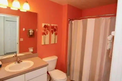 a bathroom with a toilet and a sink and a shower at Perfect vacation Gated Resort with Private Pool in Kissimmee