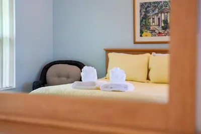 a bedroom with a bed with towels on it at Spacious Bright Close to Disney with Pool and Gym in Kissimmee