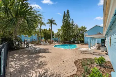 a backyard with a swimming pool and a house at Spacious Bright Close to Disney with Pool and Gym in Kissimmee