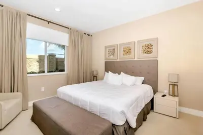 a bedroom with a large white bed and a window at Snow White Home Disney (53360775) in Orlando