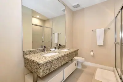 a bathroom with two sinks and a toilet at Snow White Home Disney (53360775) in Orlando