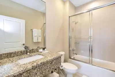 a bathroom with a sink and a toilet and a shower at Snow White Home Disney (53360775) in Orlando