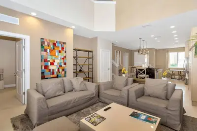 a living room with two couches and a table at Snow White Home Disney (53360775) in Orlando