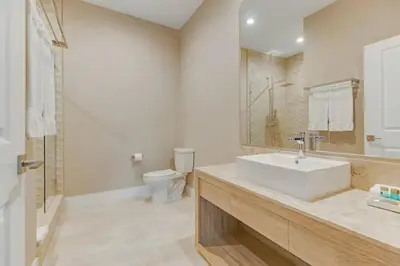 a bathroom with a white sink and a toilet at Fantasy Disney Home (45858326) in Orlando