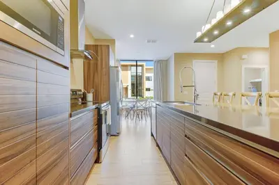 a kitchen with wooden cabinets and a counter top at Fantasy Disney Home (45858326) in Orlando
