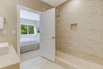 a bathroom with a shower with a glass door at Fantasy Disney Home (45858326) in Orlando