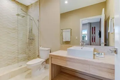 a bathroom with a sink and a toilet and a shower at Fantasy Disney Home (45858326) in Orlando