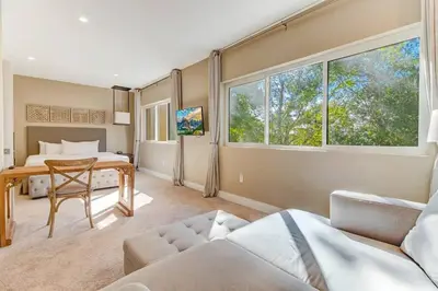 a bedroom with a bed and a table in a room at Fantasy Disney Home (45858326) in Orlando