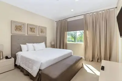 a bedroom with a white bed and a window at wish home disney (45437492) in Orlando