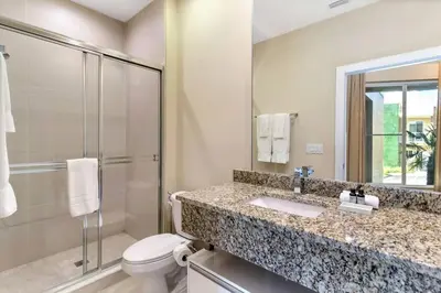 a bathroom with a sink and a toilet and a shower at wish home disney (45437492) in Orlando