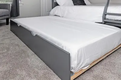 a bed with white sheets and a metal frame at Cozy Escape - Disney Universal SeaWorld in Orlando