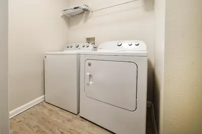 a small kitchen with a stove and a refrigerator at Cozy Escape - Disney Universal SeaWorld in Orlando