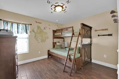 a bedroom with a bunk bed and a staircase at Royal Retreat in Orlando