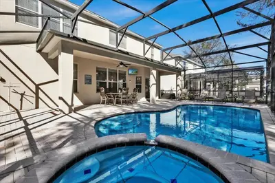 an indoor swimming pool with a glass roof at Royal Retreat in Orlando