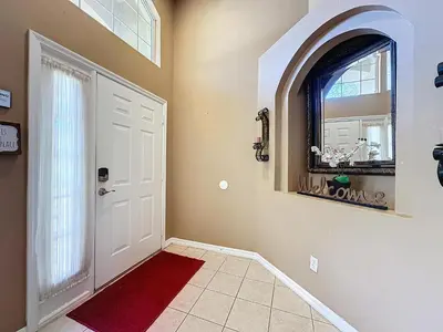 a hallway with a white door and a red rug at Four Bed in Emerald Island Resort mins to Disney in Kissimmee