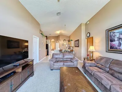 a large living room with couches and a tv at Four Bed in Emerald Island Resort mins to Disney in Kissimmee