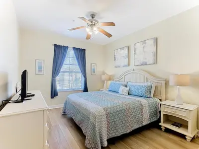 a bedroom with a bed and a ceiling fan at Two Miles Disney Pool Water Park & Water slide in Orlando