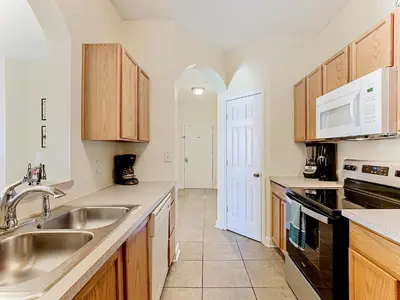 a kitchen with a sink and a microwave at Two Miles Disney Pool Water Park & Water slide in Orlando