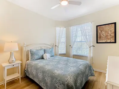 a bedroom with a bed and a ceiling fan at Two Miles Disney Pool Water Park & Water slide in Orlando