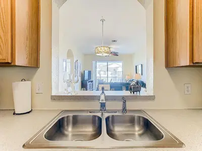 a kitchen sink with a view of a living room at Two Miles Disney Pool Water Park & Water slide in Orlando